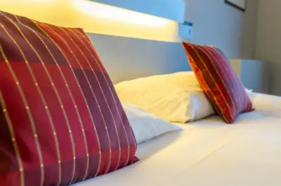 two pillows sitting on top of a bed at Hotel Ambiotel in Tongeren