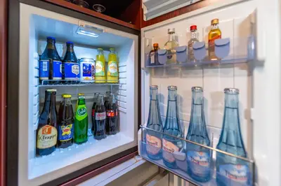 a refrigerator filled with lots of different types of drinks at Hotel Ambiotel in Tongeren