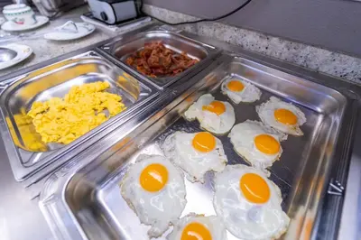 a tray of eggs and other food on a counter at Hotel Ambiotel in Tongeren