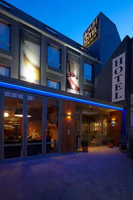 a store front of a building at night at Hotel Ambiotel in Tongeren