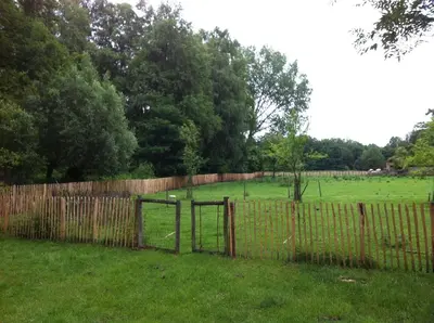 a fence with a gate in a field at De Oude Molen in As