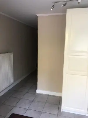 an empty room with a door and a tile floor at Vivere in Houthalen-Helchteren