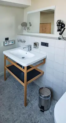 a bathroom with a sink and a mirror at Café Coureur Borgloon in Borgloon