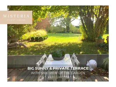a sign that says big sunny and parketeenth teenager with overview of the garden at Wisteria Guest House in Villers-lʼÉvêque