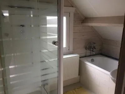 a bathroom with a shower and a bath tub at Thuiskomen, genieten aan het water in Maaseik