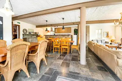 a dining room with a table and chairs at De Appelgaard in Sint-Martens-Voeren