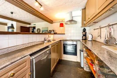 a kitchen with a sink and a dishwasher at De Appelgaard in Sint-Martens-Voeren