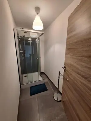a bathroom with a shower with a glass door at Gîte Cour Delhez in Olne