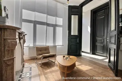 a room with a table and a chair and a door at Gats Place in Liège