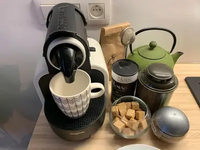 a coffee maker sitting on a table with a cup at Gats Place in Liège