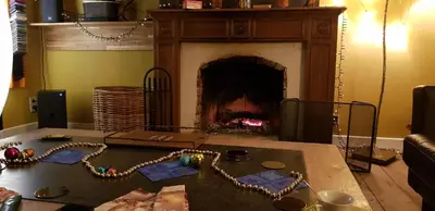 a living room with a fireplace and a table with a necklace at Espace Douffet - Un havre de paix en pleine ville in Liège
