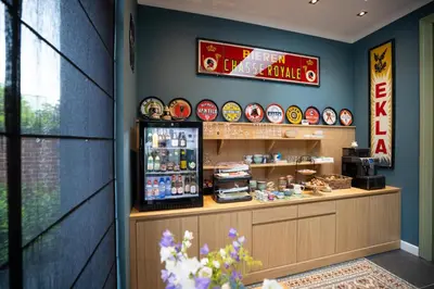 a fast food restaurant with a counter with a refrigerator at B&B Gaudium XII in Tongeren