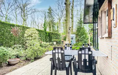 a wooden table with two chairs on a patio at Beautiful Home In Rekem-Lanaken in Bovenwezet