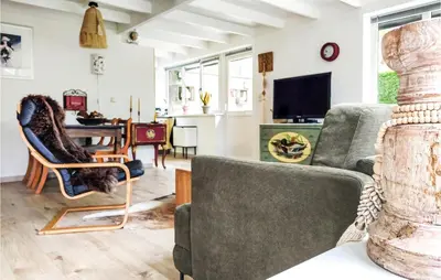 a living room with two chairs and a table at Beautiful Home In Rekem-Lanaken in Bovenwezet