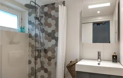 a bathroom with a sink and a shower at Beautiful Home In Rekem-Lanaken in Bovenwezet