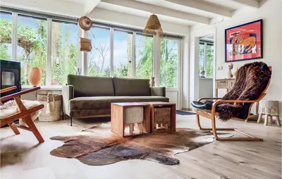 a living room with a couch and a chair at Beautiful Home In Rekem-Lanaken in Bovenwezet