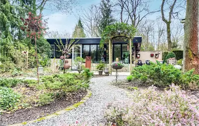 a house with a garden with flowers and plants at Beautiful Home In Rekem-Lanaken in Bovenwezet