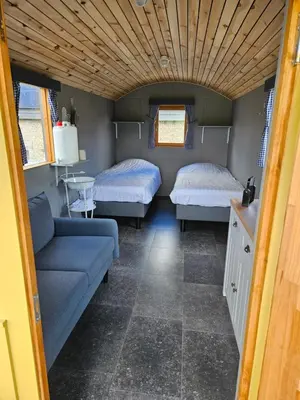 a room with two beds and a couch in it at B&B Hoeve De Brieser in Heers