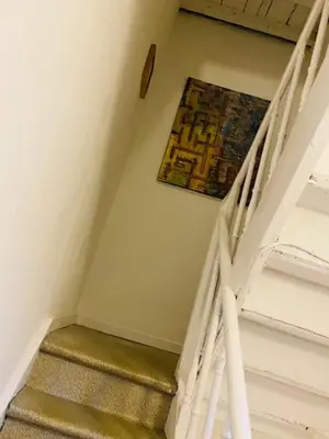 a stairway with a painting hanging on the wall at Roture 88 in Liège