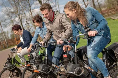 a group of people riding bikes down a street at Vakantiewoning Vennekens in Peer