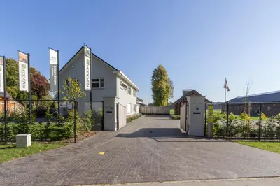 a driveway in front of a white house at Vakantiewoning Vennekens in Peer
