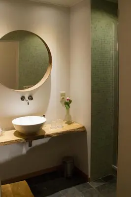 a bathroom with a sink and a shower at PuurTeuven B&B tussen Kunst en Natuur in Voeren