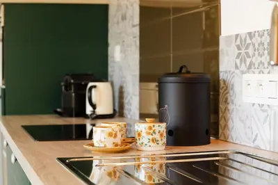 a kitchen counter with two coffee mugs on a counter at Time-Out Zussen in Riemst
