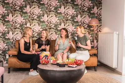 a group of four women sitting on a couch with microphones at Time-Out Zussen in Riemst