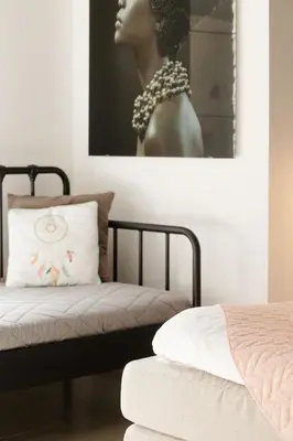 a bedroom with a bed and a picture of a woman at Time-Out Zussen in Riemst