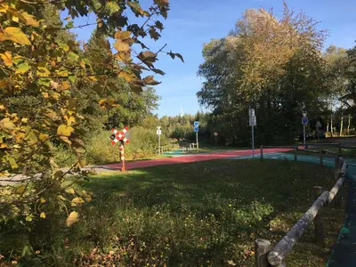 a park with a road in the distance at Hotel-Restaurant Zum Onkel Jonathan in Raeren