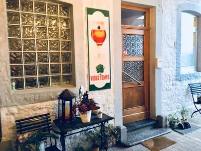 a entrance to a building with a table and a door at Hotel-Restaurant Zum Onkel Jonathan in Raeren
