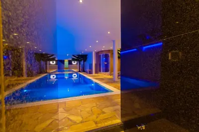 a swimming pool in the middle of a house at Hotel Pracha in Borgloon