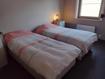 two beds sitting next to each other in a bedroom at Hasbania Vakantiewoning in Gingelom