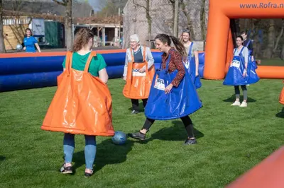 a group of people wearing aprons on a playground at Kamphuis Heideven in Peer