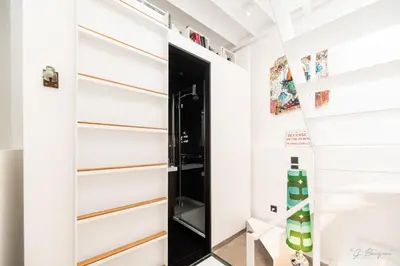 a room with white walls and a black door at Logement insolite La tour de Larbuisson in Herve