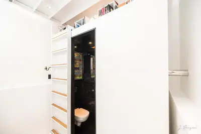 a bathroom with a toilet through a door at Logement insolite La tour de Larbuisson in Herve