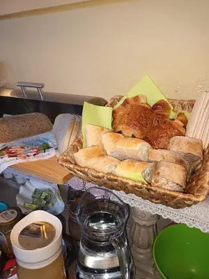 a basket of bread and pastries on a table at B&B Chatelet Cremers in Verviers