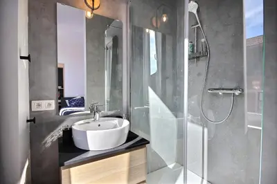 a bathroom with a sink and a shower at Tokyo's Place in Liège