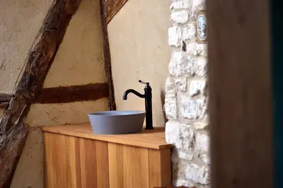a bathroom with a sink on a wooden counter at Vakantiewoning Veurservallei in Voeren