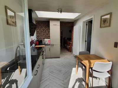 a small kitchen and dining room with a table and chairs at Haspengouws Hoeveke in Borgloon