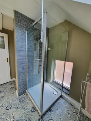 a shower with a glass door in a bathroom at Haspengouws Hoeveke in Borgloon