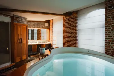 a bathroom with a large tub in a room at Baiser de Cupidon in Verviers