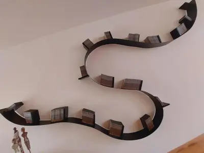 a wall with three wooden shelves on a wall at Baiser de Cupidon in Verviers