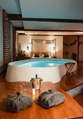 a swimming pool with two towels on a table at Baiser de Cupidon in Verviers