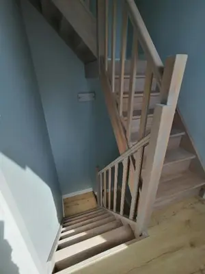 a wooden staircase in a room with blue walls at Le Boisseliège in Liège