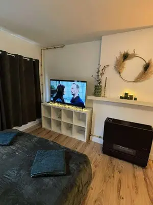 a bedroom with a bed and a flat screen tv at In The Air cosy room (Cœur Historique de Liège) in Liège