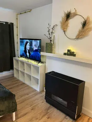 a living room with a flat screen tv and a flat screen at In The Air cosy room (Cœur Historique de Liège) in Liège