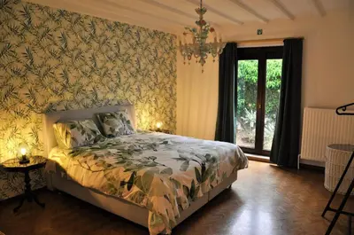 a bedroom with a bed with a floral wallpaper at Spelver95 in Bilzen