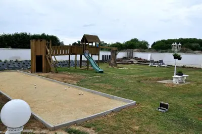 a playground with a slide in a yard at Spelver95 in Bilzen