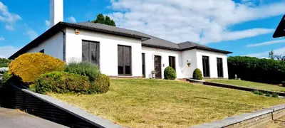 a white house with a grassy yard at Spelver95 in Bilzen